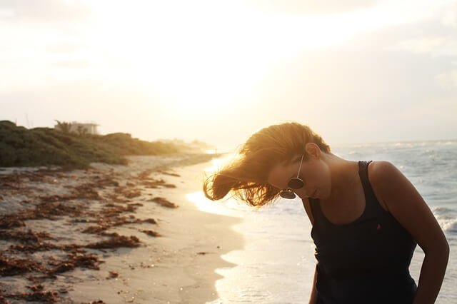 Kobieta w okularach przeciwsłonecznych nad morzem